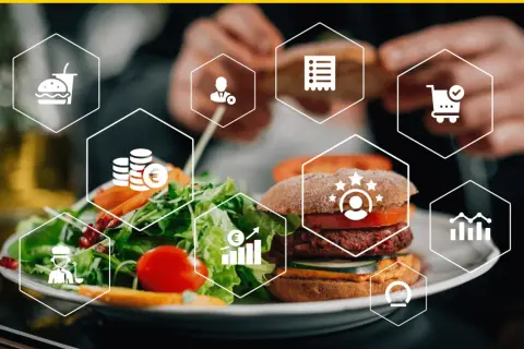 Plato de hamburguesa y ensalada con iconos que representan el **food service**: pedido, pago, cliente, gráfico y más.